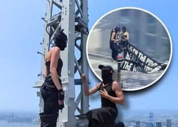 Daredevil climbers scale to the top of the empire state building—raise a banner for peace, get engaged, and then arrested