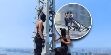 Daredevil climbers scale to the top of the empire state building—raise a banner for peace, get engaged, and then arrested